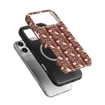 Thicket iPhone case featuring a floral design in burgundy and cream, layered over black and clear cases.