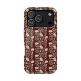 Thicket iPhone case featuring a floral pattern on a dark maroon background with a glossy finish.