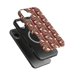 Thicket iPhone case featuring a floral pattern on a maroon background, layered over a black phone case.