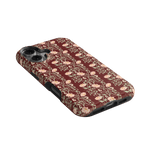Thicket iPhone case featuring a floral pattern in shades of pink and burgundy on a black background.