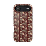 Thicket iPhone case featuring a floral pattern with pink flowers on a dark red background.