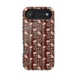 Thicket iPhone case featuring a floral pattern with pink flowers on a dark red background.