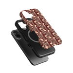 Thicket iPhone case featuring a floral design in burgundy and cream, layered over a black phone case.