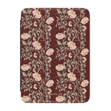 Thicket Kindle case featuring a floral pattern in pink and green on a burgundy background.