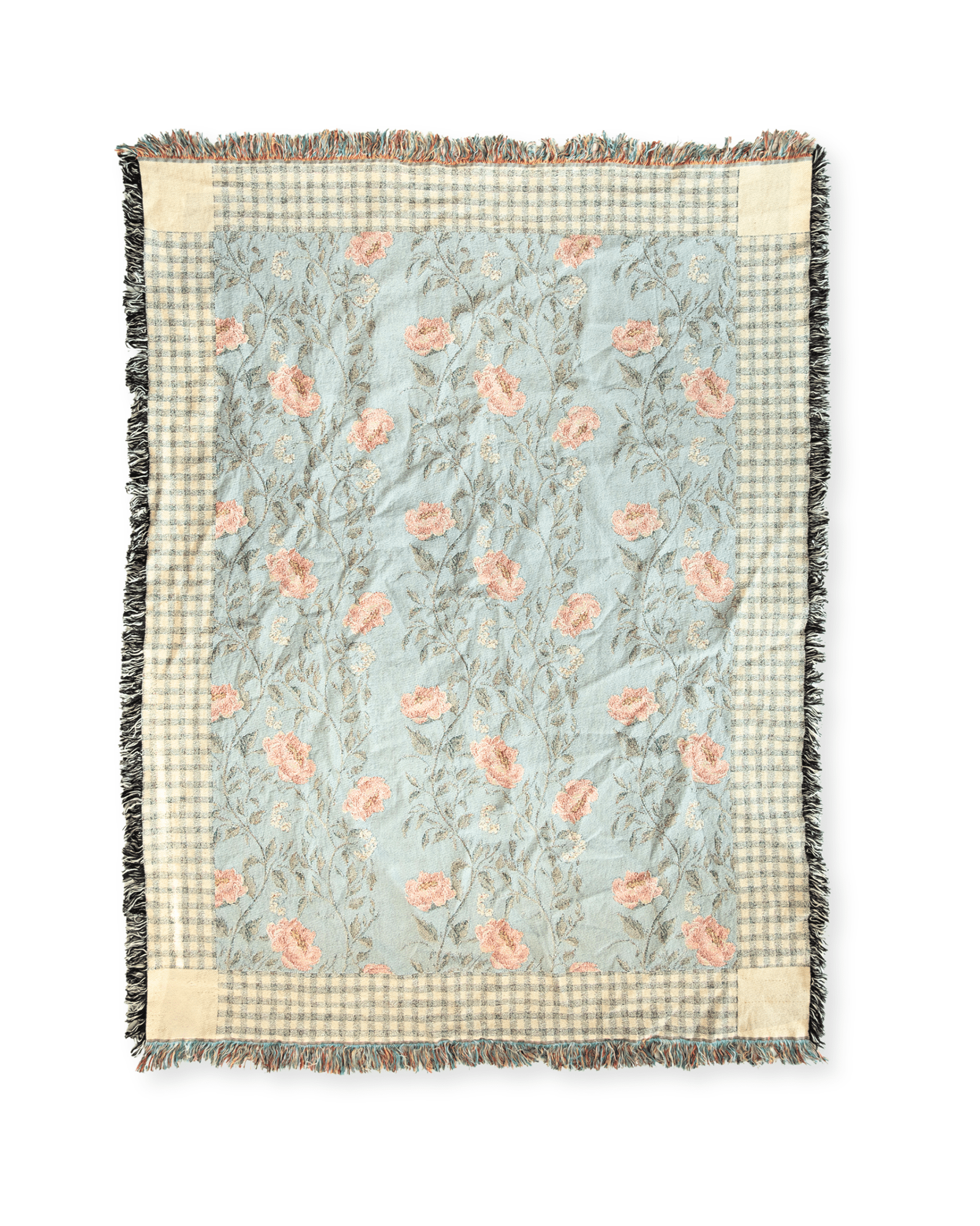 Thicket woven blanket featuring a floral pattern in soft pink and green on a light blue background with fringed edges.
