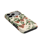 Tomato vines iPhone case featuring a floral design with red tomatoes on a cream background.