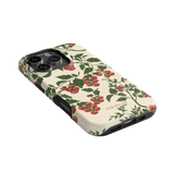 Tomato vines iPhone case featuring a cream background with red cherry tomatoes and green leaves design.