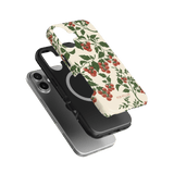 Tomato vines iPhone case featuring a floral design with red tomatoes on a cream background, shown from multiple angles.