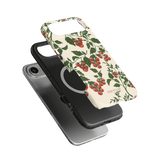 Tomato vines iPhone case featuring a floral design with red tomatoes on a cream background, shown from multiple angles.