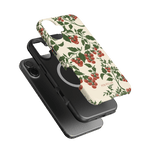 Tomato vines iPhone case featuring a floral design with red tomatoes on a cream background, shown with a black phone.