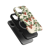 Tomato vines iPhone case featuring a floral design with red tomatoes on a cream background, shown from multiple angles.