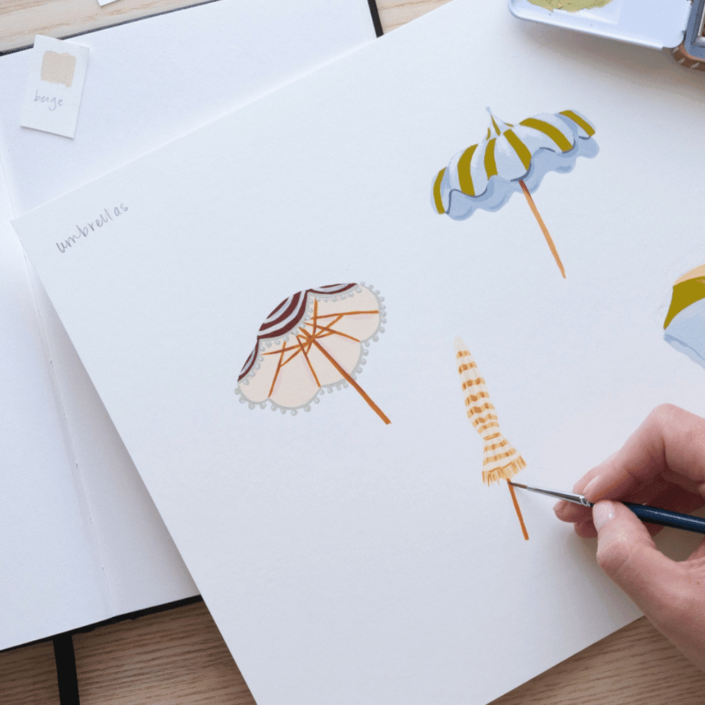 A hand painting striped beach umbrella illustrations on white paper with the word umbrellas written in the corner.