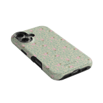 Vine+Bloom iPhone case featuring a floral design with pink flowers on a green background, angled view.