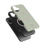Vine+Bloom iPhone case featuring a floral design with pink flowers on a green background, stacked with a black case.