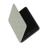 Vine+Bloom Kindle case with a floral pattern, partially open, showing the Kindle device inside.