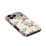Viola iPhone case featuring a floral design with pink and green accents on a light background.