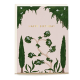 Whimsical birthday card featuring green foliage and a pink background with "Happy Birthday" in gold lettering.