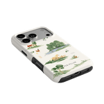 Willow iPhone case featuring a landscape design with trees, houses, and water in green and beige colors.