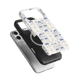 Woodland iPhone case featuring a white design with blue animal illustrations, layered over a black phone case.