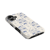 Woodland iPhone case featuring a blue and white animal print design on a cream background, angled view.