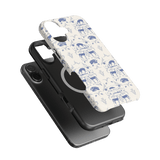 Woodland iPhone case featuring a blue and white animal print design on a light background, with a black case underneath.
