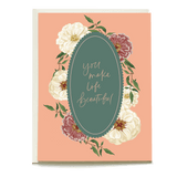 Zinnias love and friendship card featuring floral designs and the text "you make life beautiful" on a peach background.